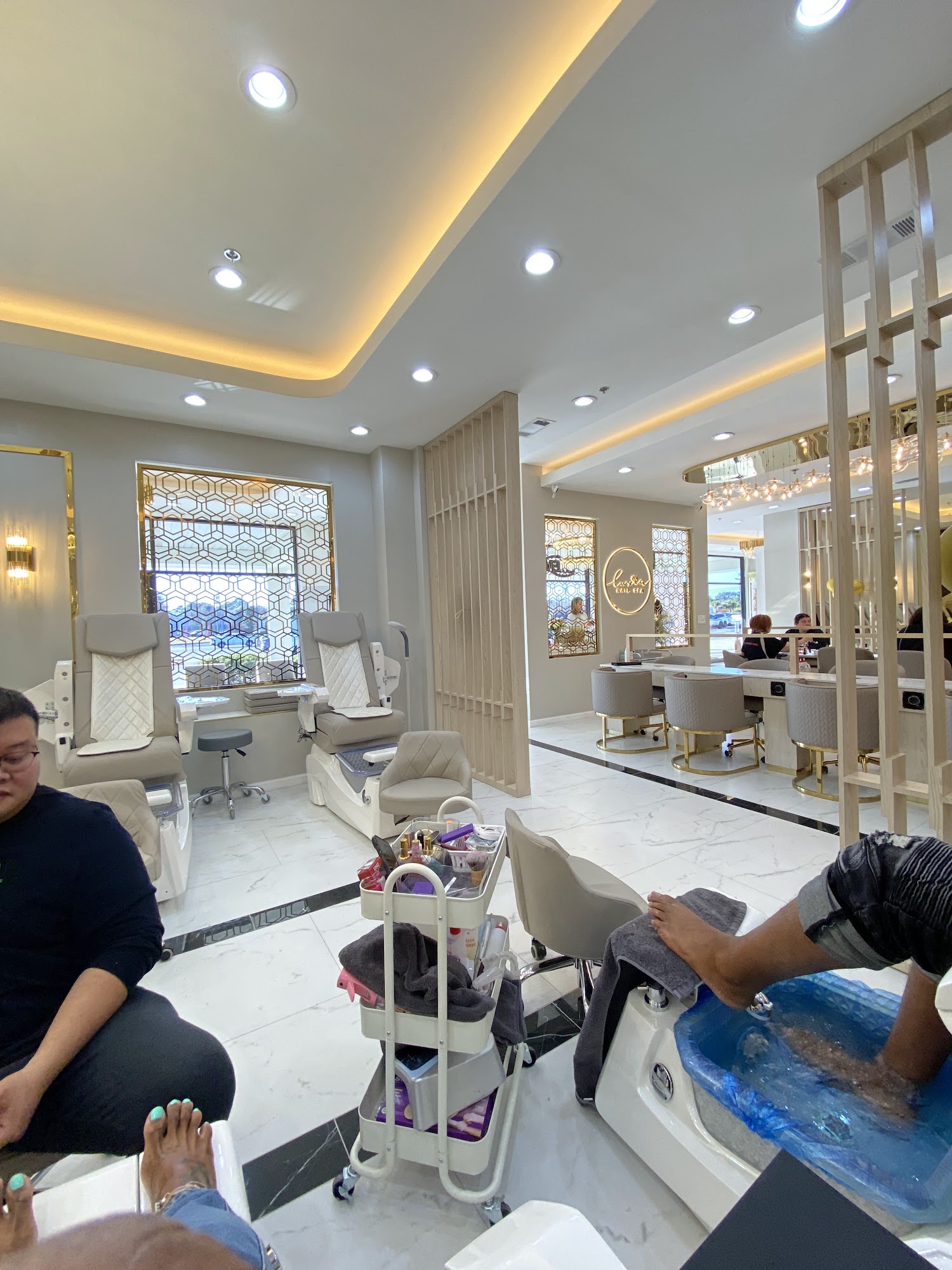 Cozy pedicure area with geometric window screens and warm lighting