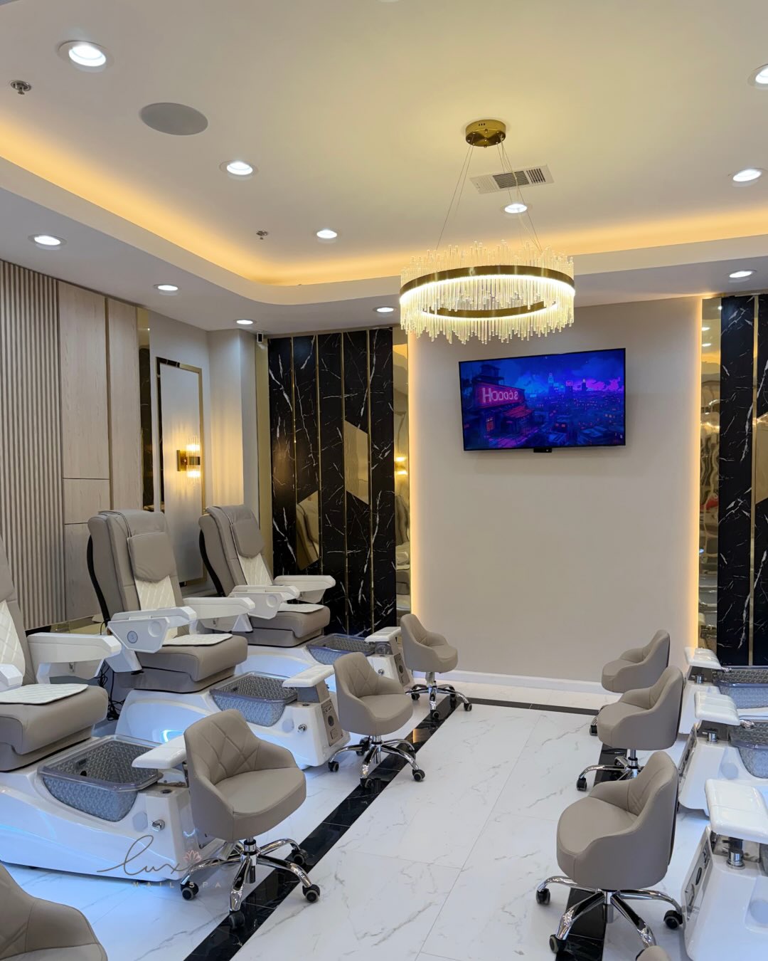 Luxia North Charleston pedicure area with crystal chandelier and black marble accents